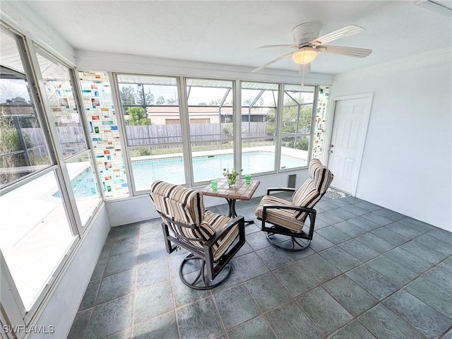 sunroom featuring ceiling fan