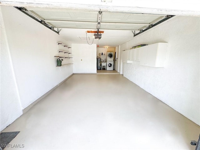 garage with a garage door opener and washer and dryer