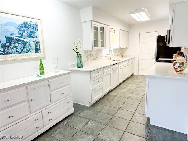 kitchen featuring white cabinetry, dishwasher, sink, backsplash, and tile patterned flooring