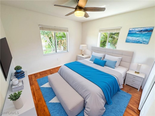 bedroom with light hardwood / wood-style floors and ceiling fan