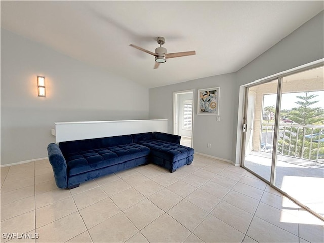 living area with light tile patterned floors, vaulted ceiling, and ceiling fan