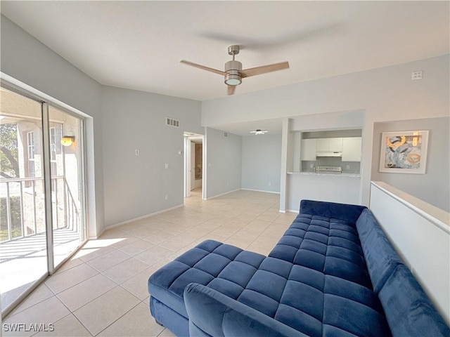 living room with light tile patterned floors and ceiling fan