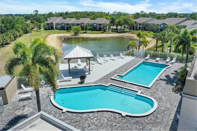 view of swimming pool featuring a gazebo, a water view, and a patio