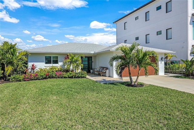 view of front facade featuring a garage and a front lawn