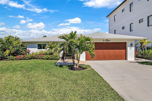 view of front of house with a garage and a front yard