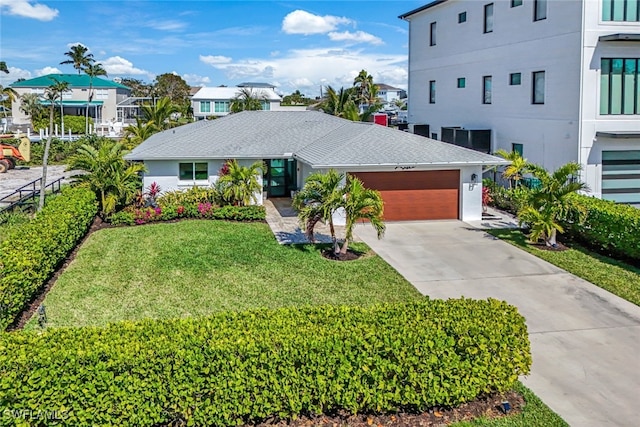 view of front of house with a garage and a front yard