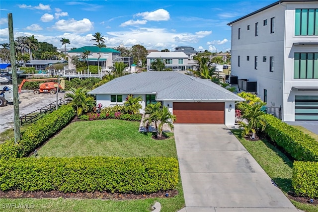 view of front of property with a garage and a front yard