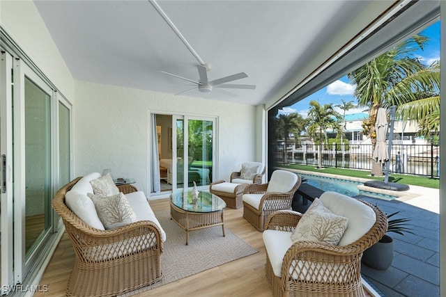 sunroom featuring ceiling fan