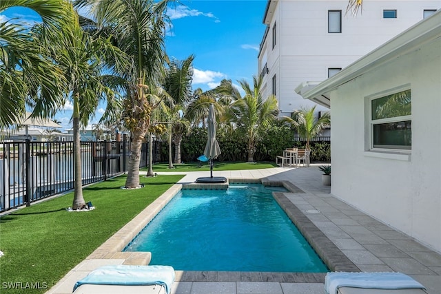 view of swimming pool with a yard and a patio area