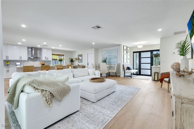 living room with a healthy amount of sunlight and light hardwood / wood-style flooring