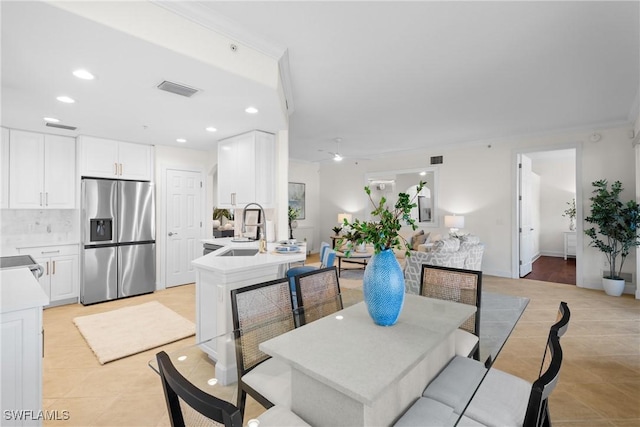 dining space featuring sink and light tile patterned floors