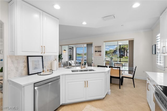 kitchen featuring appliances with stainless steel finishes, kitchen peninsula, sink, and white cabinets