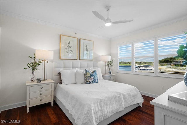 bedroom featuring ornamental molding, dark wood-type flooring, and ceiling fan