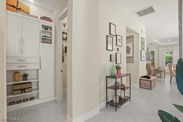 hall featuring recessed lighting, visible vents, and baseboards