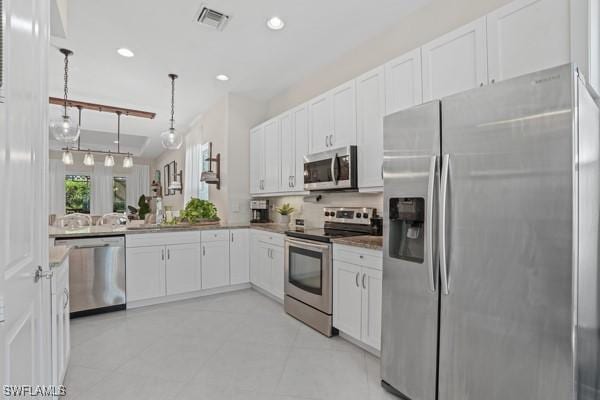 kitchen featuring recessed lighting, stainless steel appliances, visible vents, and white cabinetry