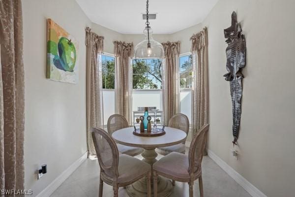 dining space featuring baseboards and visible vents