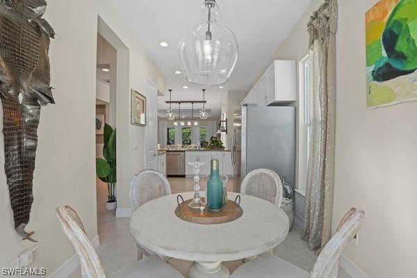 dining room with recessed lighting and baseboards