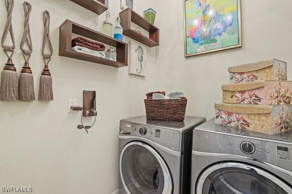 clothes washing area with laundry area and washer and dryer