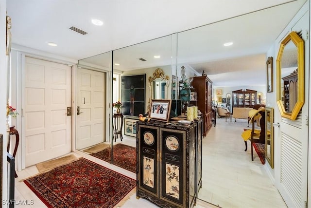 foyer featuring recessed lighting and visible vents