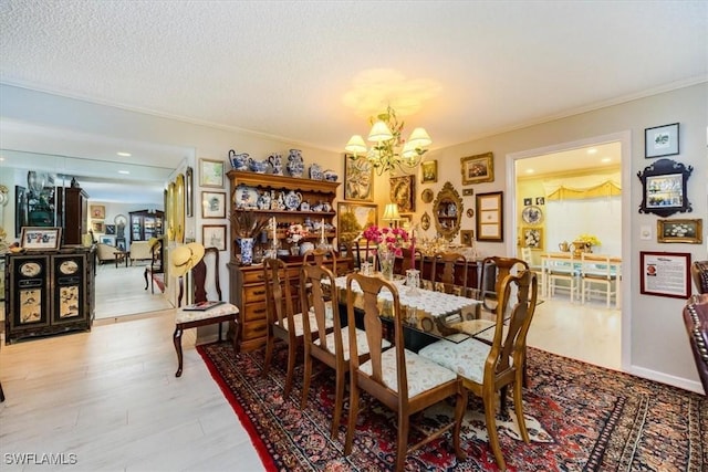 dining area featuring a notable chandelier, ornamental molding, a textured ceiling, wood finished floors, and recessed lighting