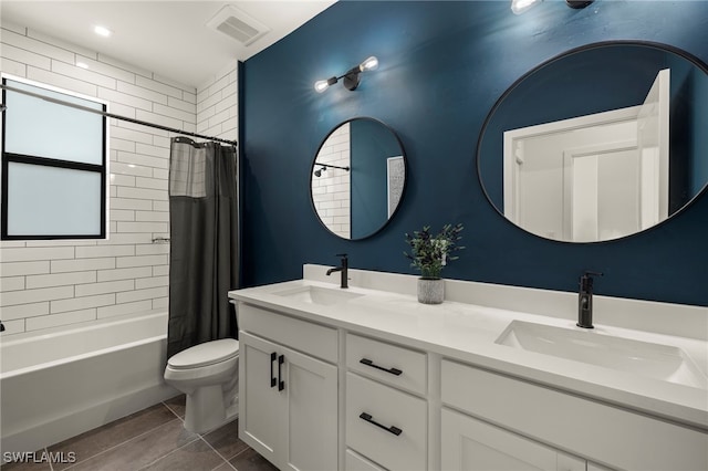 full bath with visible vents, a sink, toilet, and shower / bath combo with shower curtain