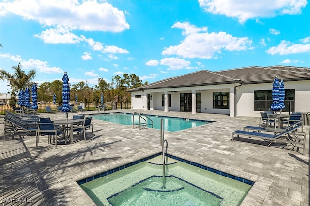 community pool featuring a patio and fence