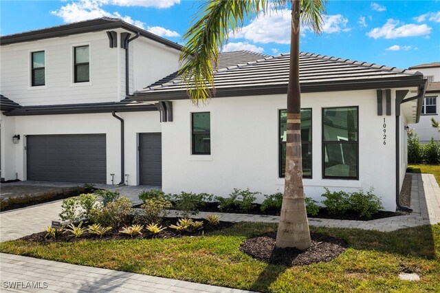 view of front of property with a garage and a front yard