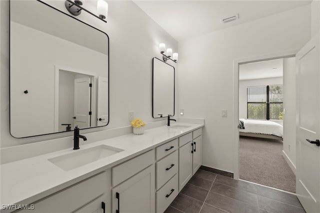 full bath featuring visible vents, a sink, ensuite bath, and double vanity