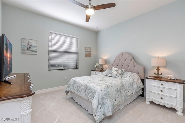 bedroom featuring a ceiling fan, light carpet, and baseboards