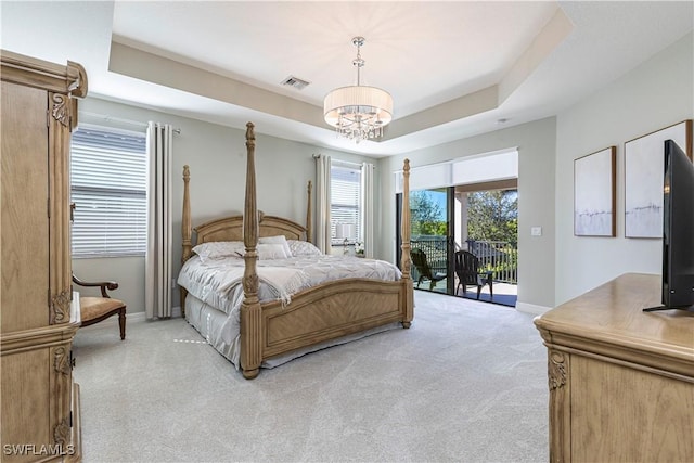 bedroom with access to exterior, visible vents, a raised ceiling, and light colored carpet