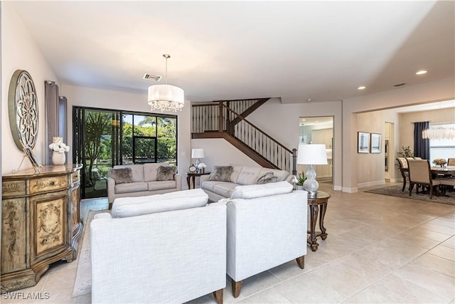 living area featuring light tile patterned floors, visible vents, an inviting chandelier, stairs, and recessed lighting