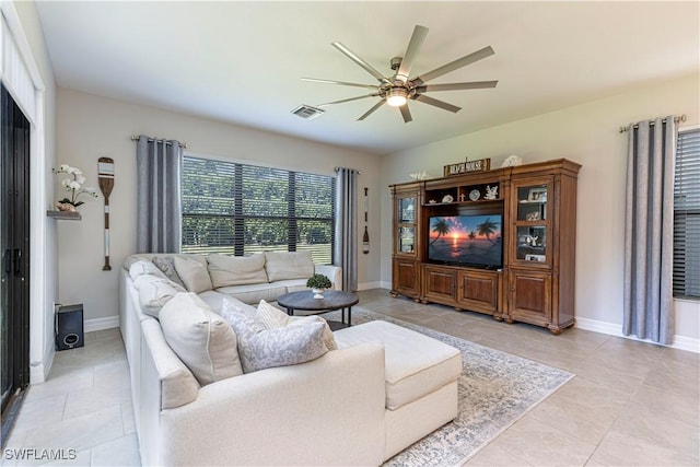 living room with ceiling fan, light tile patterned floors, visible vents, and baseboards