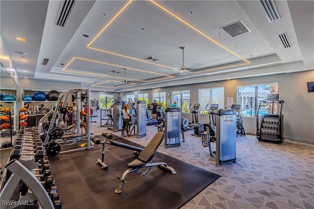 gym featuring a raised ceiling and visible vents