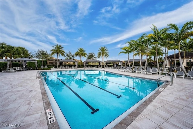 community pool with a patio and a pergola