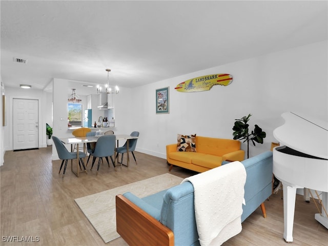 9831 Alabama St Unit 5, Bonita Springs, FL 34135 - living room with an inviting chandelier and light hardwood / wood-style floors