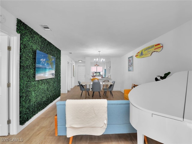 9831 Alabama St Unit 5, Bonita Springs, FL 34135 - living room with a notable chandelier and light hardwood / wood-style flooring