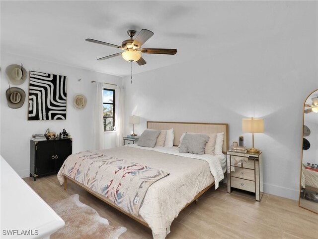 9831 Alabama St Unit 5, Bonita Springs, FL 34135 - bedroom with light hardwood / wood-style floors and ceiling fan
