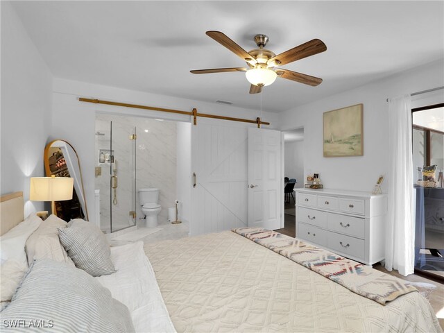9831 Alabama St Unit 5, Bonita Springs, FL 34135 - bedroom with ceiling fan, connected bathroom, and a barn door