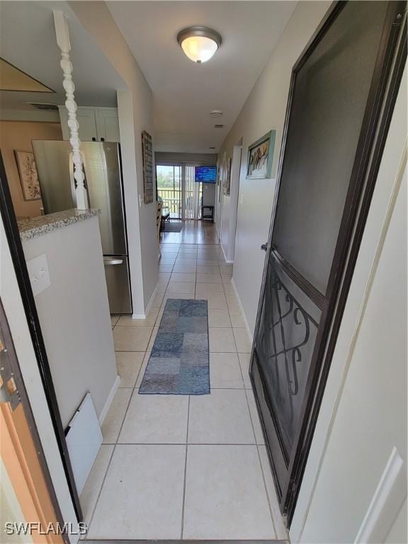 corridor with light tile patterned floors