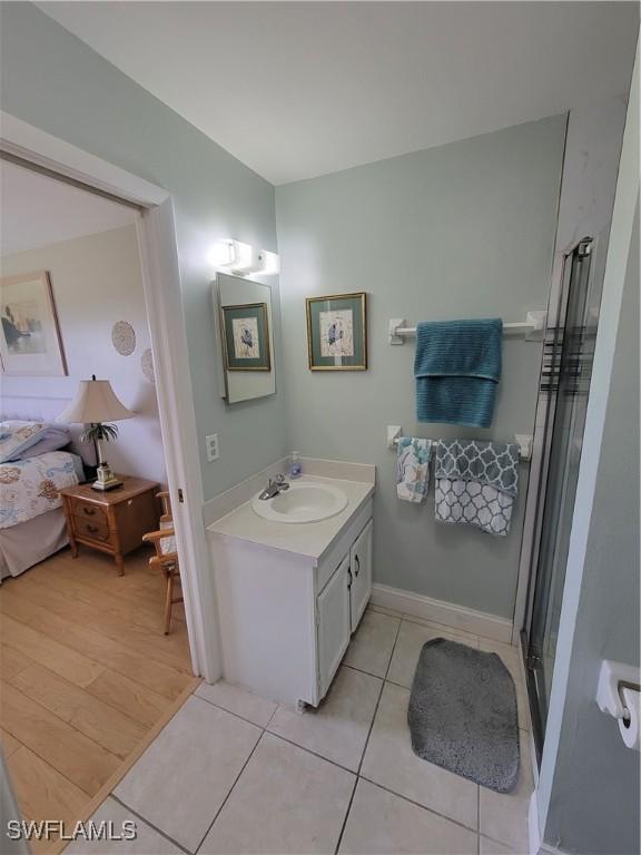 bathroom with vanity, hardwood / wood-style floors, and walk in shower