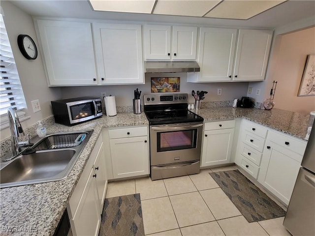 kitchen featuring light tile patterned flooring, white cabinetry, sink, light stone counters, and stainless steel appliances