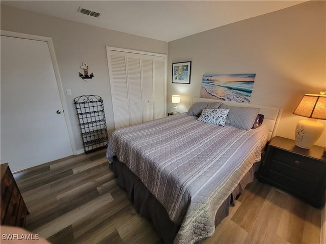 bedroom with hardwood / wood-style flooring and a closet