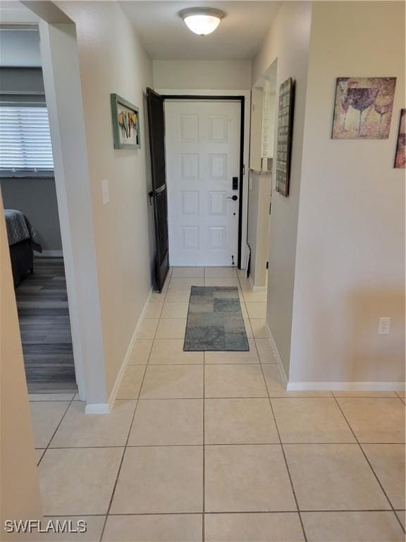 doorway to outside featuring light tile patterned flooring