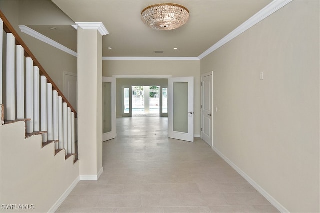 entrance foyer with crown molding and french doors