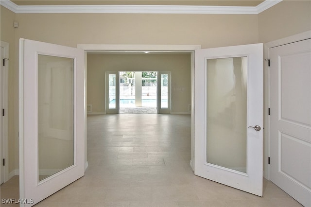 corridor featuring french doors and ornamental molding