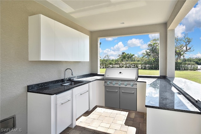 view of patio / terrace featuring a grill, an outdoor kitchen, and sink