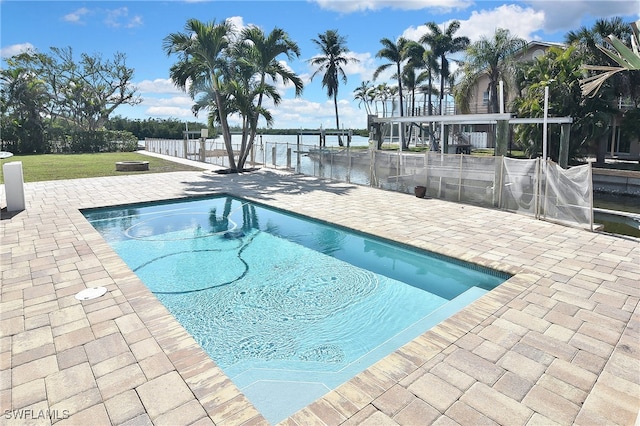 view of pool with a water view and a patio area