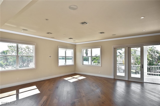 empty room featuring dark hardwood / wood-style flooring and ornamental molding