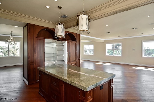 kitchen featuring crown molding, dark wood-type flooring, and a kitchen island