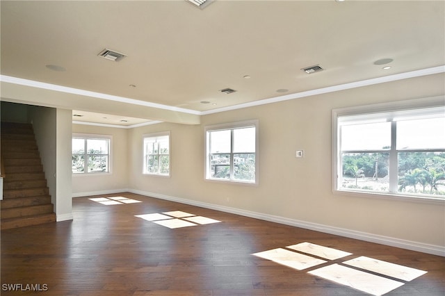 spare room with crown molding and dark hardwood / wood-style floors